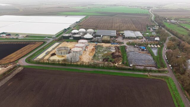 Aerial drone view of a commercial glasshouse and adjacent biogas renewable energy plant in Cambridgeshire, UK