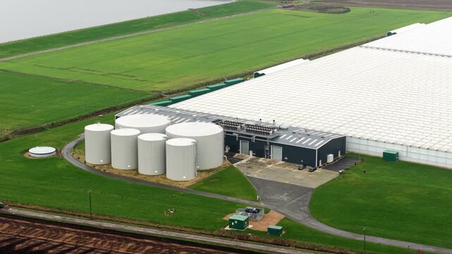 Aerial drone view of a commercial glasshouse and green energy production facility in Cambridgeshire, UK