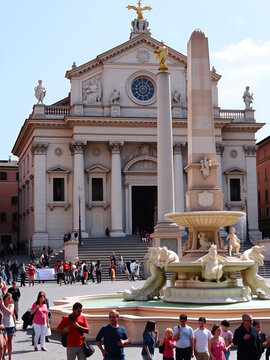 Rome, Italy. Sant Agnese in Agone baroque Church and Fountain of Four Rivers (Fontana Dei Quattre Fiumi) obelisk in Piazza Navona Square. Tourists visit ancient Roman architecture.