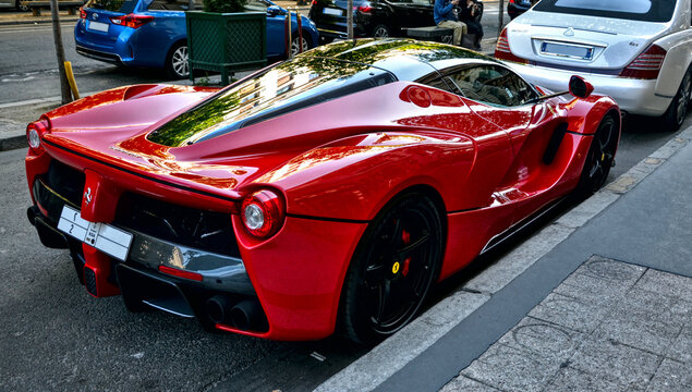 Rear of a Ferrari LaFerrari (Ferrari F70) parked in a street in Paris, april 2015 18th. Producted since 2013, there is 500 copies in the world. You can also see a Bugatti Veyron behind.