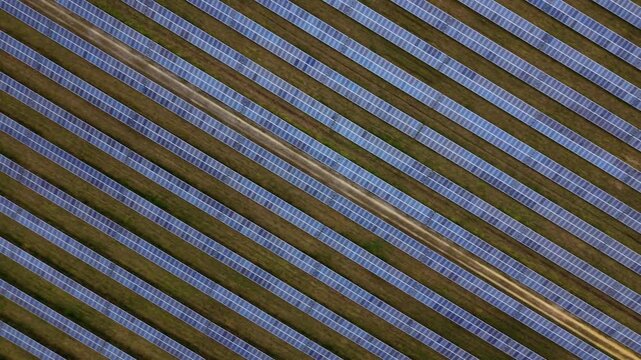 Aerial drone view of a solar panel array on the former RAF Alconbury site, renewable energy infrastructure under cloudy UK skies in Cambridgeshire.