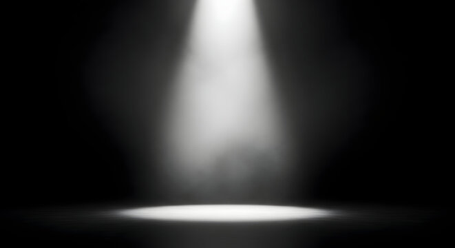 A single bright spotlight illuminates a dark stage creating an atmospheric and dramatic effect with visible dust particles dancing in the light beam