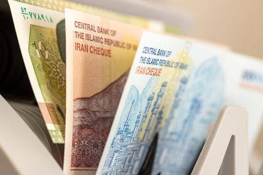Iran money. Banknotes in a money counter. Financial concept. Close up