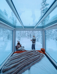 Cozy winter retreat in Akaslompolo's glass cabin surrounded by snowy Lapland wilderness © Fokke Baarssen