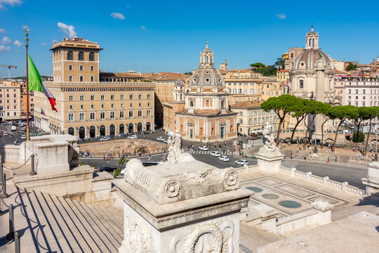 Architecture of Venice square (Piazza Venezia) with Palazzo delle Assicurazioni Generali palace, churches and Trajan column, Rome, Italy