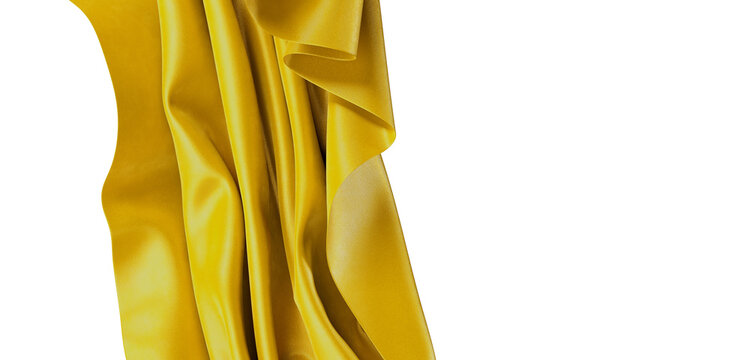 Close-up of golden fabric with beautiful folds, perfect for background use. This luxurious cloth offers a feeling of ric