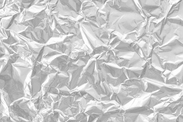 Obraz premium Shiny silver foil texture background, pattern of wrapping paper with crumpled and wavy.