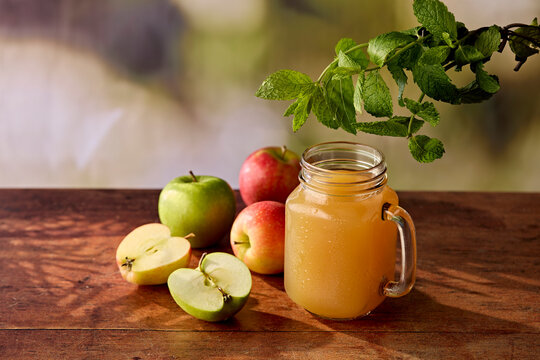 Fresh Apple Juice in Jam Jar Glass with Apples and Mint on Dark Wooden Surface