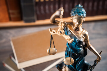 Justice-themed statue with scales, gavel, and books, symbolizing fairness, equality, and the principles of law and moral judgment.
