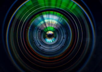 Close-up of Professional Camera Lens with Colorful Reflections and Optical Coating,An abstract macro shot looking directly into the glass elements of a high-quality camera lens, showcasing vibrant. © banjongseal324