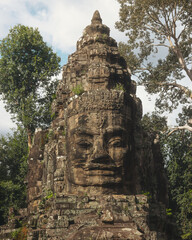 Ancient Khmer Stone Face at Bayon Temple Surrounded by Jungle