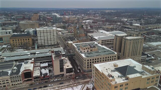 Drone aerial of downtown Akron Ohio buildings church towers and winter cityscape