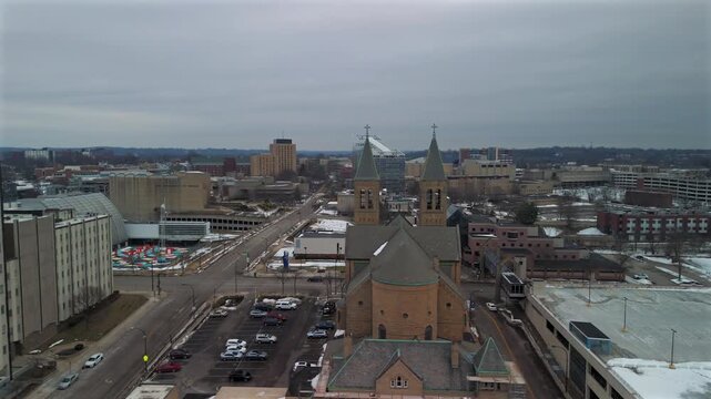 Drone view of historic twin tower church in downtown Akron Ohio winter