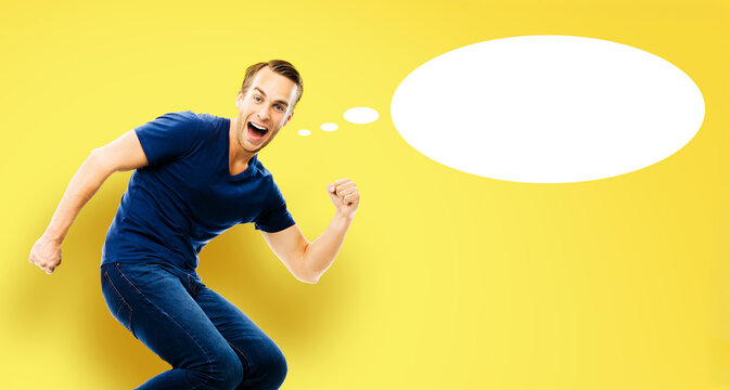 Ideas, inspiration, expressing thoughts, sales, enthusiasm, success concept - young man jump run with raised hand fist, open-mouthed smile, isolated yellow background. White empty think speech bubble