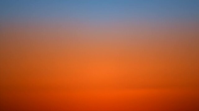 Beautiful gradient sunset with orange hues transitioning to a tranquil blue sky