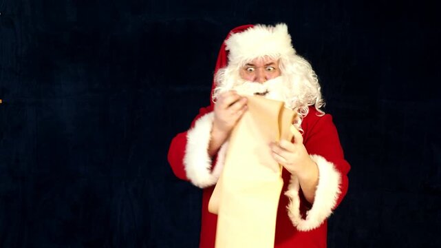 Santa Claus looking at long list with children desire