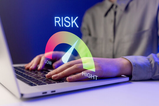 Measuring risk using a laptop with a risk scale indicating low to high levels in a digital workspace setting