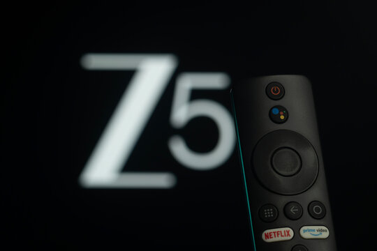 Dhaka, Bangladesh- 21 Jan 2026: Close-up of a smart TV remote control against a blurred ZEE5 logo.