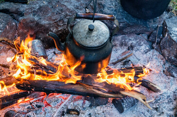 Tourist camp, kettle on the campfire.