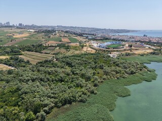 Obraz premium High Altitude Aerial Drone View of Curved Coastal Bay, Seaside Residential District and Scenic Marmara Sea Shoreline in Turkey on a Clear Summer Day