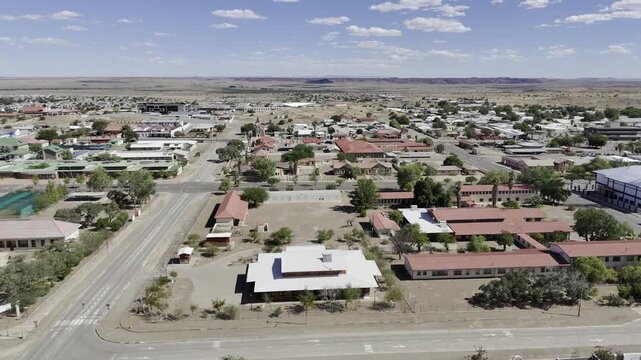 Drone flies south down 3rd Avenue on sunny afternoon in Keetmanshoop, Namibia
