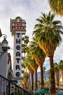 The Plaza Theatre Marquee and Palm-Lined Street in Downtown Palm Springs, California at Sunrise