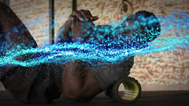 Man using foam roller, shifting, releasing upper back in gym, blue wave sweeping across body