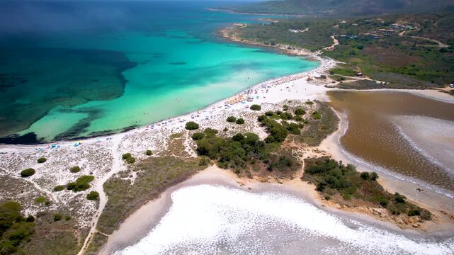 Sardinia Isuledda Beach aerial FPV flight over salt lakes to turquoise sea through low clouds and mist San Teodoro Italy white sand coast drone footage 4k cinematic landscape travel destination