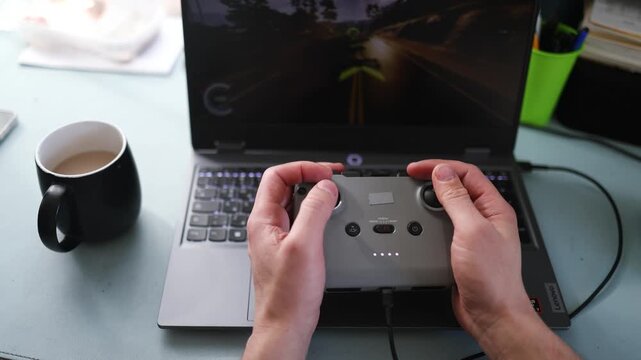 flight simulator concept. Male hands hold the joystick from the fpv drone on the background of a blurry monitor.