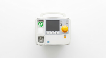 Fototapeta premium Top-Down View of a Vital White Medical Emergency Defibrillator with Screen, Array of Controls, Large Yellow Dial, and Essential Warning Symbol