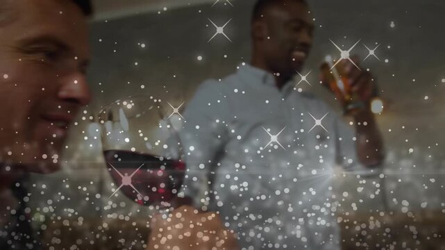 Host starting toast, group celebrating dinner, clinking, sipping wine, sparkles filling frame