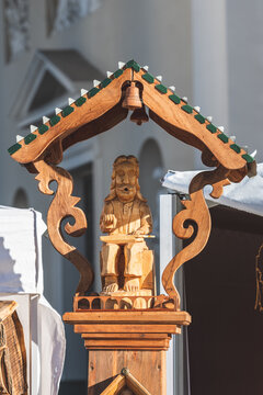 Wooden sculpture of a kankles player in a folk arts and crafts fair or market in Vilnius, Lithuania, Europe 