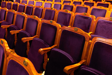 Obraz premium Close-up of Purple Velvet Theater Seats with Golden Wooden Frames