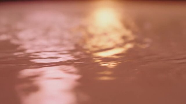 Abstract Golden Liquid Surface with Gentle Ripples and Soft Light