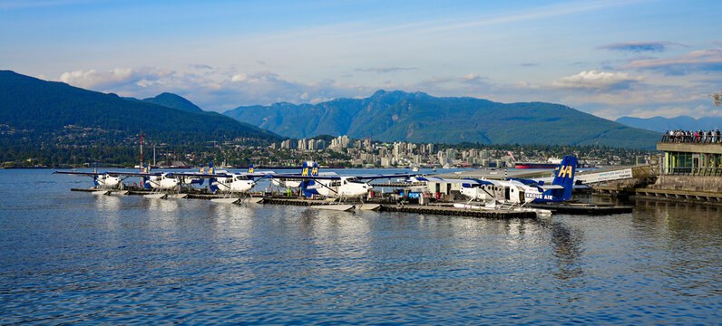 Lineup of seaplanes in Vancouver Harbour Flight Centre - Seaplane terminal of Vancouver Airport made of pontoons floating in Coal Harbour, British Columbia, Canada
