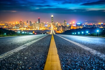 Fototapeta premium Asphalt Highway Leading into Illuminated Cityscape at Night with Selective Focus 