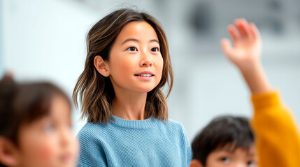 Fototapeta premium Asian female teacher listening to student raising hand in classroom active learning education concept
