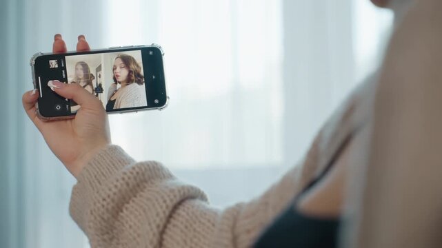 Woman Taking Selfie, Woman Carefully Editing Her Selfie Setup In Cozy Environment, Individual Adjusting Phone Angle And Composition While Dressed Comfortably Indoors During Soft Daylight