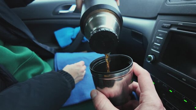 Sealing Travel Mug. Thermos Lid Fastened After Pouring Coffee. Driver Seals Travel Mug Before Beginning Journey. Person Seals Thermos Tightly After Pouring Coffee Into Cup During Stopover