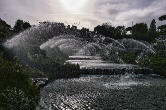Water splashing on a tiered fountain creating a refreshing outdoor scene