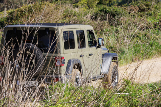 Jeep wrangler rubicon driving off road on dirt path
