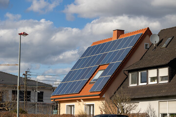 Fototapeta premium Photovoltaic system on the roof of a detached house generates solar power
