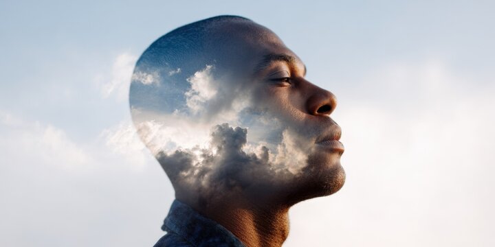 African male adult profile double-exposure clouds sky meditation serenity inner landscape calm