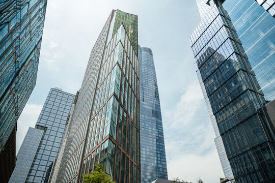 Tall modern glass towers rising into the sky in Manhattan, New York City. Contemporary skyscrapers define the urban skyline and architectural landscape.
