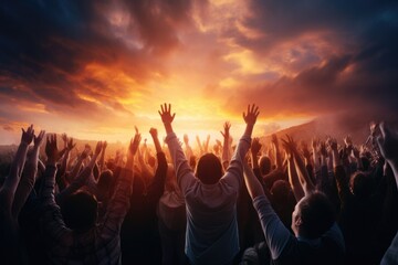 A picture capturing a group of people raising their hands in the air. This image can be used to showcase unity, celebration, support, or achievement.