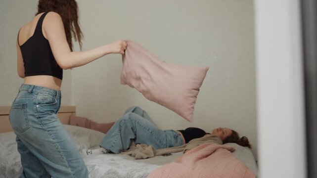 Hidden Pillow Attack With Playful Atmosphere, Casual Scene Of Friend Startling Sleeping Companion Quietly, Scene Depicting Lighthearted Prank As Friend Surprises Roommate Through Sheer Curtain