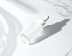 White frosted glass dropper bottle with shadows on a marble surface, representing skincare