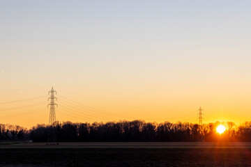 Naklejka premium A beautiful sunset with a power line in the background