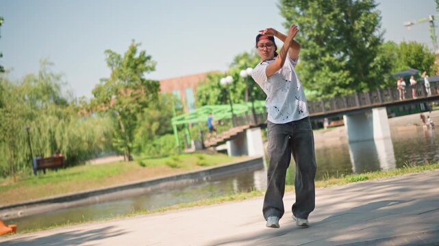 rollerblader practicing freestyle moves by riverbank, young man in cap and patterned shirt gliding and pivoting along sunlit pathway with bridge and trees in background scenes alternate