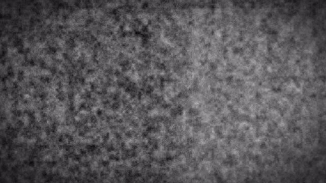 Exploring a grainy texture in a dark gray speckled field, captured as a 4K glitch background with Alpha Channel support, close‑up studio perspective